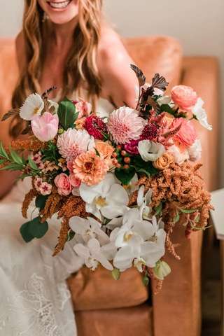Bride holding natural colorful bouqet