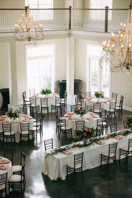 Large event with roses, flowers, and greenery