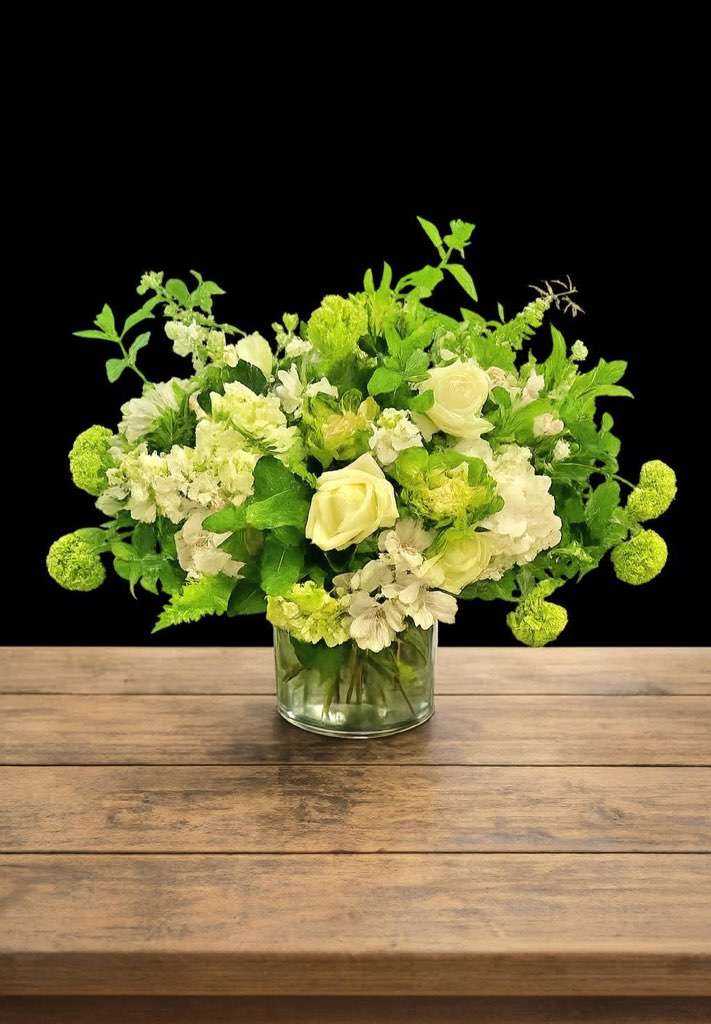 White flowers with greenery on wooden table